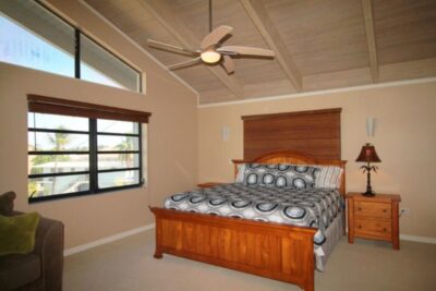 Spacious bedroom with vaulted wood ceilings