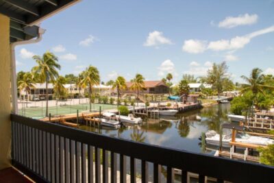 Main floor balcony overlooking the canal, pool & tennis courts