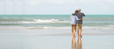 Asian senior couple enjoy on the beach