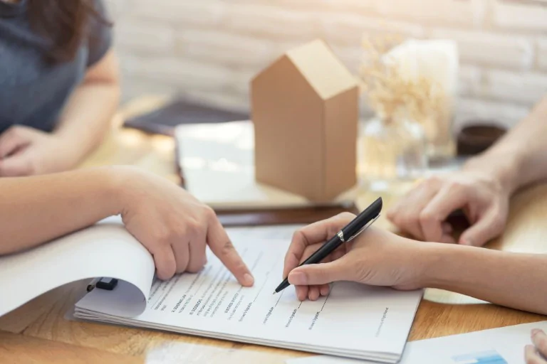 Woman signing a document for her newly purchased waterfront home in Marathon FL