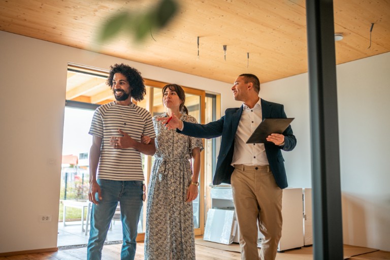 Real Estate Agent Guiding Prospective Buyers