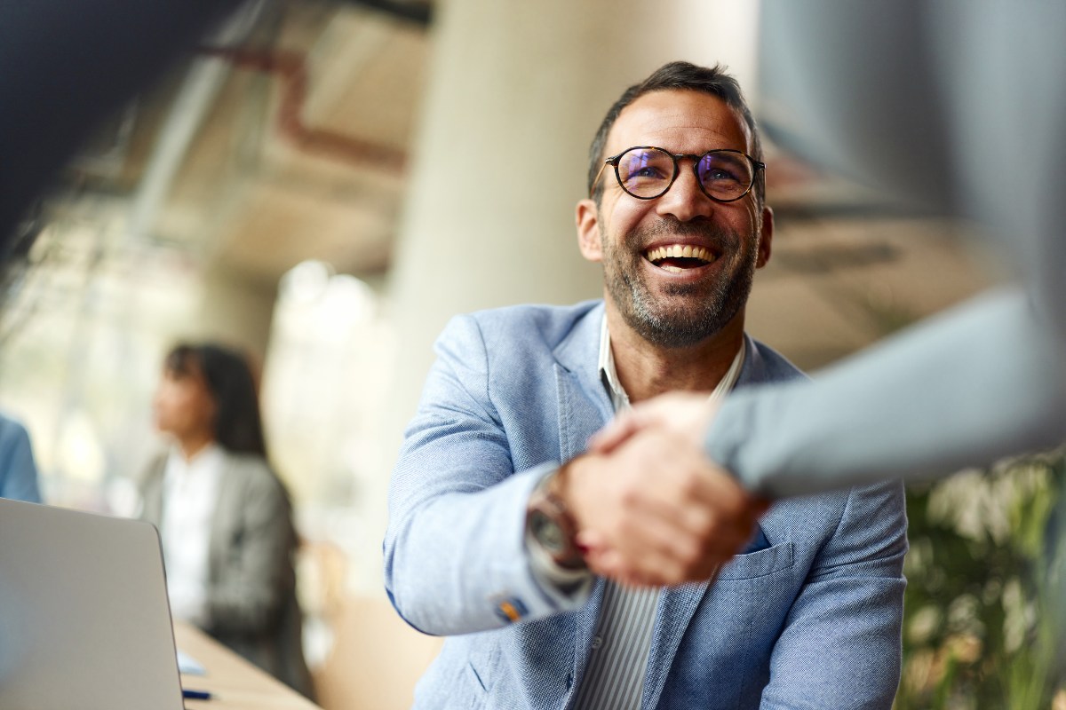 Happy businessman shaking hands with his colleague