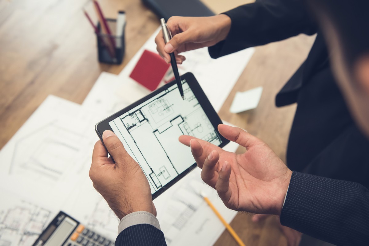 man looking on floorplan